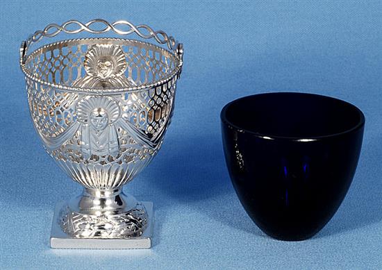A George III silver swing handled sugar basket with blue glass liner, height to top of handle 5 ¾”/147mm Diameter 3”/79mm.